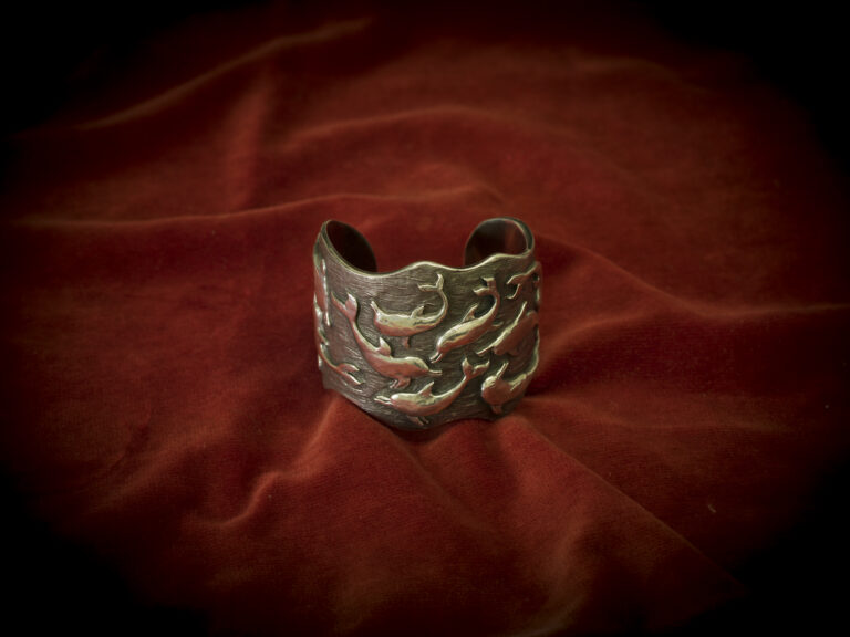 Silver Dolphin Bangle With Tarnished Background by Philip Blacker